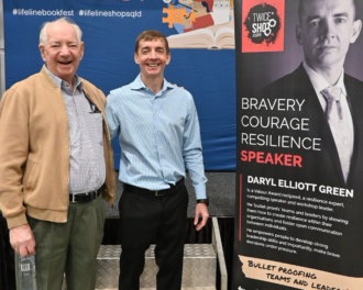 Photo Of Daryl Elliott Green And His Father Alan In Front Of A Large Lifeline Bookfest Banner At The Lifeline Brisbane Bookfest Event On Saturday 17 June 2023, Just After Daryl Spoke To Attendees.